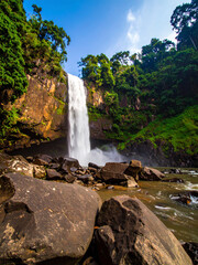 Vibrant Tropical Waterfall with Silky Flow and Rich Sunlit Jungle Landscape