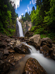 Vibrant Tropical Waterfall with Silky Flow and Rich Sunlit Jungle Landscape