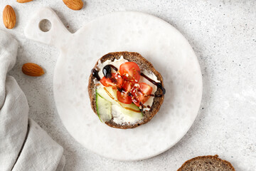 Toast with cream cheese, tomato and sliced cucumber on wholemeal bread. Bruschetta, sandwich on...