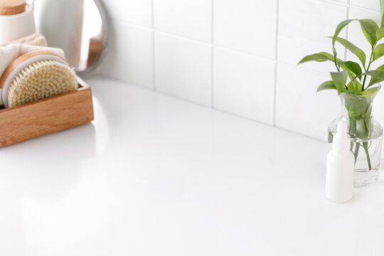 Background for product presentation for cosmetic, mock up. Tile, white cosmetic table with mirror
and accessories. Bathroom view.