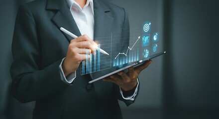 Businesswoman Analyzing Financial Data on Tablet with Stylus Presenting Growth Charts and Investment Opportunities in the Digital Age