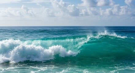 Fototapeta premium A powerful ocean wave crashes and breaks, creating white foam and splashes against the deep blue water