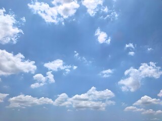 A wide view of white fluffy clouds in a blue sky