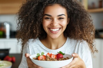 Happy woman enjoying healthy breakfast with granola and strawberries