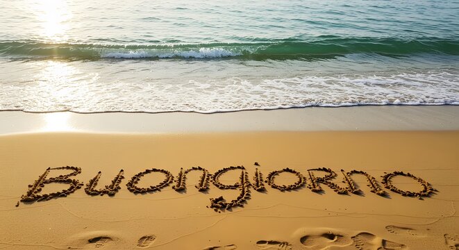 Buongiorno written in the sand on a beautiful beach with the ocean waves gently washing ashore
