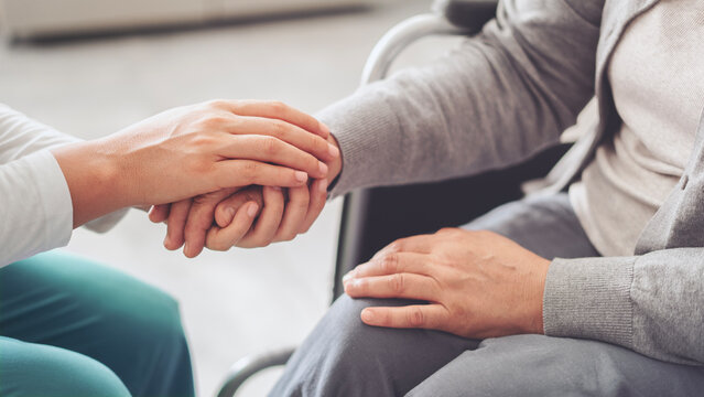 Young carer giving helping hands for the elderly woman - Powered by Adobe