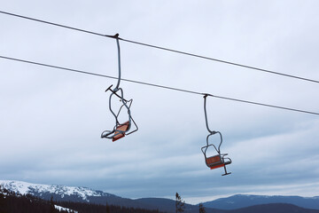 An empty chairlift hung above the snowy landscape