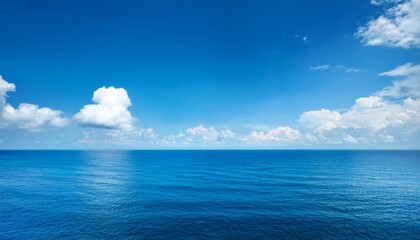 Fototapeta premium calm ocean view under a clear blue sky with clouds