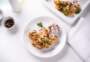 Cauliflower steak with spices and herbs. Healthy vegan organic cuisine.