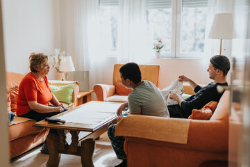 Three family members engage in a discussion within a warmly lit living room, emphasizing warmth and inter generational bonding.