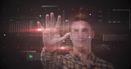 Man in yellow flannel shirt interacting with holographic interface with panels, red streaks in lab