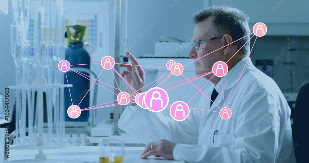 Poster gesturing researcher wearing lab coat pointing at digital network icons in lab with glassware racks