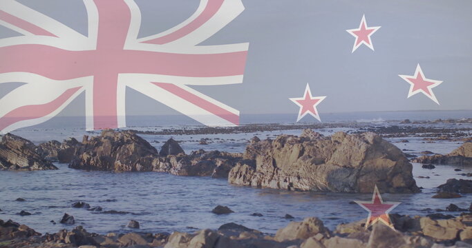 Naklejki Showing rocky shoreline at low tide with jagged rocks in calm water, New Zealand flag overlay