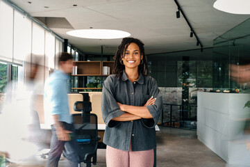 Success woman with diverse employees walking in background, business coworking space