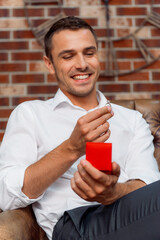 Man Holding Engagement Ring in Romantic Proposal Setup