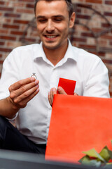 Man Holding Engagement Ring in Romantic Proposal Setup