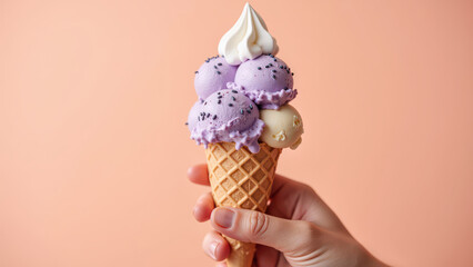 Delicious ice cream cone with three colorful scoops, topped with whipped cream and sprinkles, evokes joy and sweetness
