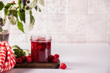 Homemade raspberry jam with fresh berries