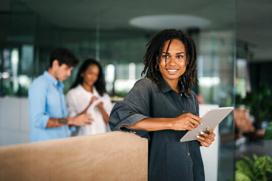 Group of young multi-ethnic startup business team collaborating on project in modern office