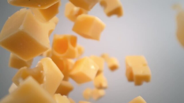 Super Slow Motion Shot of Cheese Cubes Falling Around Camera at 1000 fps.