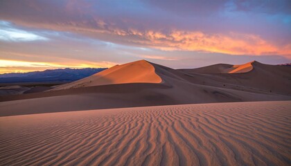 Stunning Sunset Over Windswept Sand Dunes in a Desert Landscape with Colorful Sky and Rippled Patterns on Sandy Terrain