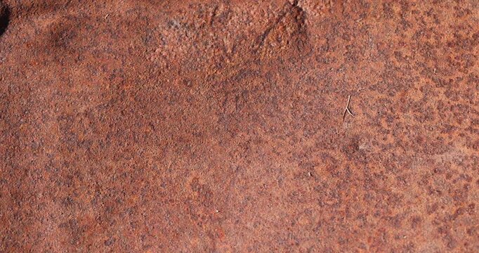 a rusty metal surface made of steel and an alloy of metals, the details of a part of a metal alloy structure covered with red rust spots
