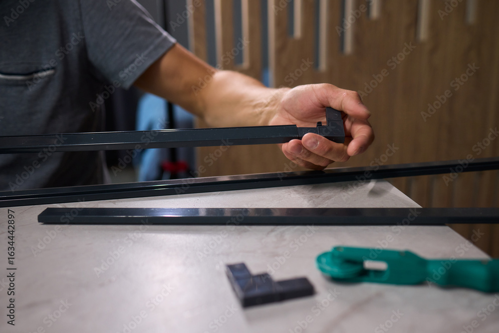 Aufkleber hand assembling a frame on a beautiful and modern table in a creative workspace