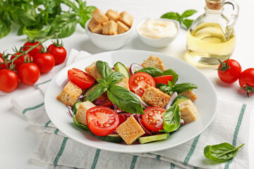 Delicious salad with croutons and ingredients on white wooden table, closeup