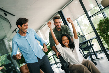 Portrait of overjoyed young diverse employees workers in creative modern office. Team building
