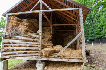 hay storage barn with green trees in the background
