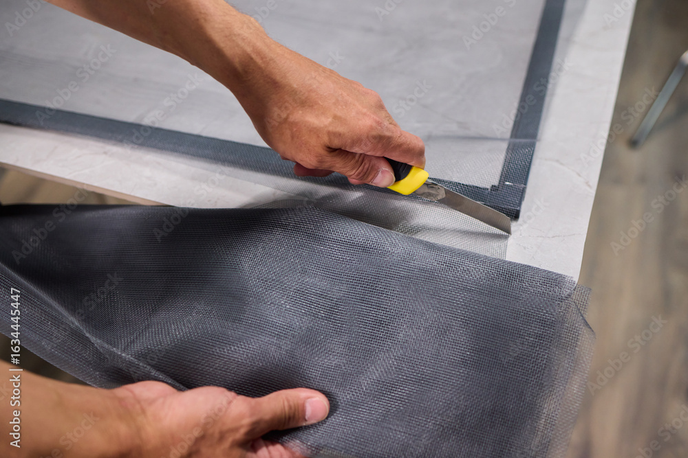 Aufkleber hand assembling a frame on a beautiful and modern table in a creative workspace