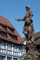Fototapeta premium Gengenbach, Germany, July 12 2025: The knight known as ‘Schwed’ has stood in the market square for more than 500 years, leaning on his shield bearing the city coat of arms.