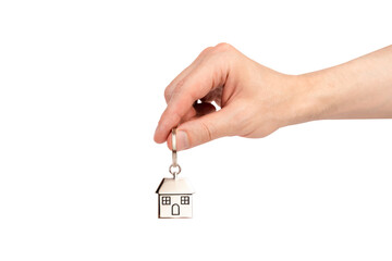Man's hand holding the keychain with house isolated on white background. Sale, purchase, rent of...