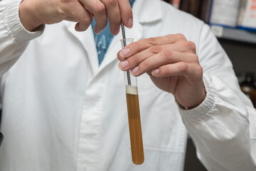 Close up detail of a scientist working with substances in a laboratory.