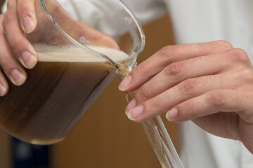 Close up detail of a scientist working with substances in a laboratory.
