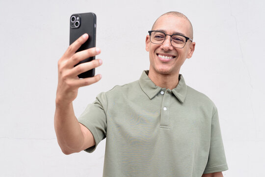 Hispanic bald man in polo shirt isolated on white background, studio portrait for business and lifestyle - Powered by Adobe
