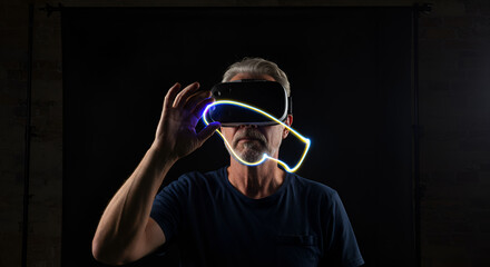 Man in VR headset with light trail against black backdrop, modern technology concept