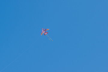 Kite against clear blue sky