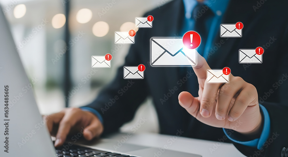 Poster person interacting with digital email notifications and messages on a virtual interface with a lapto