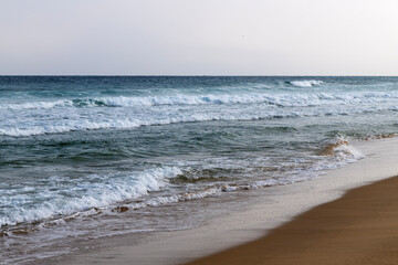 tranquil winter seascape with waves on the beach