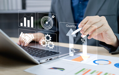 Cost and quality control concept. Businessman pointing virtual graph showing cost reduction and...