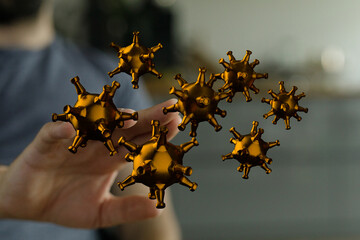 3D render of gold virus particles on a person's hand.  Medical, science concept.
