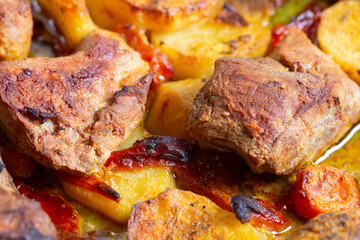 roasted pork with potatoes and carrots in tray