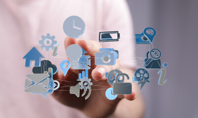 Hand interacting with a network of app icons.  Digital technology, connection, interface.