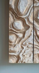 Close-up of a carved wood panel, light beige and off-white, showing intricate, flowing patterns resembling geological formations or abstract waves