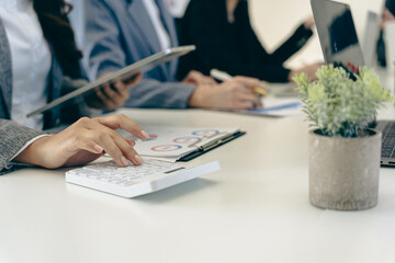 Business people discussing charts and graphs showing results of successful teamwork, stock market...