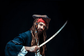 Intense Pirate with Sword and Tricorn Hat in Studio Portrait on Black Background
