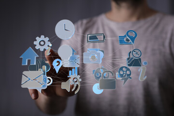Person interacting with a digital network of app icons. Technology, connection, internet.