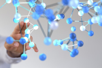Abstract image of a hand interacting with a complex molecular structure.  Perfect for science,...