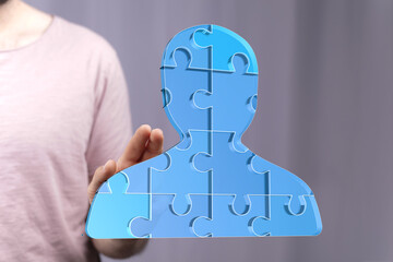Abstract image of a person formed by puzzle pieces, symbolizing teamwork, collaboration, and unity.